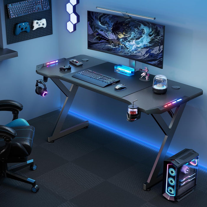 63 INCH Gaming Desk with LED Lights, Home Office Gamer Desk, Ergonomic Computer Table with Large Carbon Fiber Desktop, Office Workstation with Mouse Pad, Cup Holder & Headphone Hook, Black - ShipItFurniture