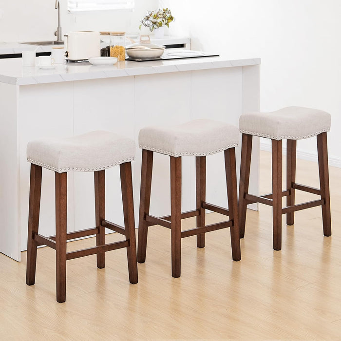 26 Inch Solid Wood Saddle Backless Bar Stools Set of 3, Beige | Counter Height Barstools with Footrest & Nailhead Trim, Modern Farmhouse Upholstered Linen Counter Stools for Kitchen Island